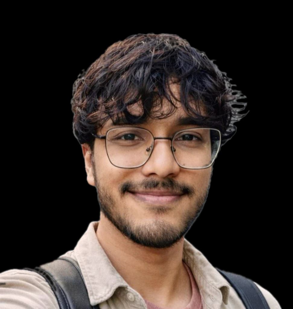 Pranjal Sailwal, smiling, in glasses, with dark curly hair and a short beard.
